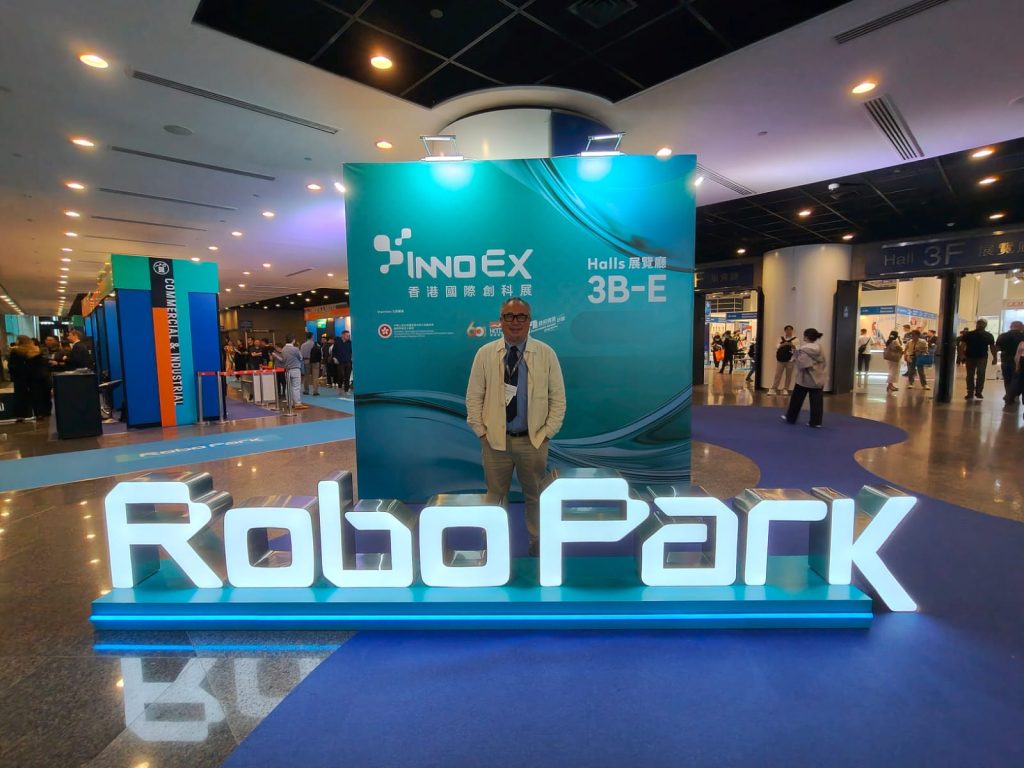 humanoid robots standing next to me at RoboPark exhibit, InnoEX 2026 Hong Kong, with AgiBot, Unitree, UBTECH
