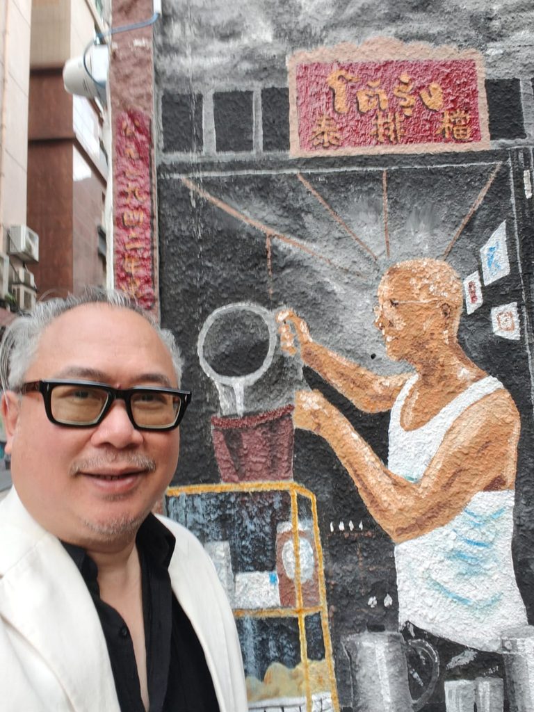 A vibrant street-art mural by Japanese artist Shingo Katori at the intersection of Hollywood Road and Shelley Street, painted directly beneath the Central–Mid-Levels Escalator.