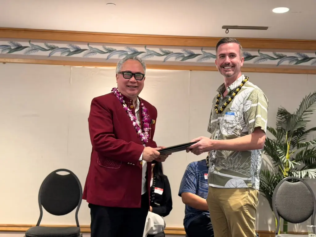 Rusmin Lawin presents Regent Rinto Wardana's Mentawai letter to Council member Matt Weyer